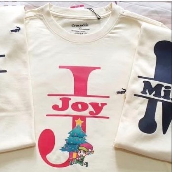 Cream holiday shirts printed with Joy and festive artwork